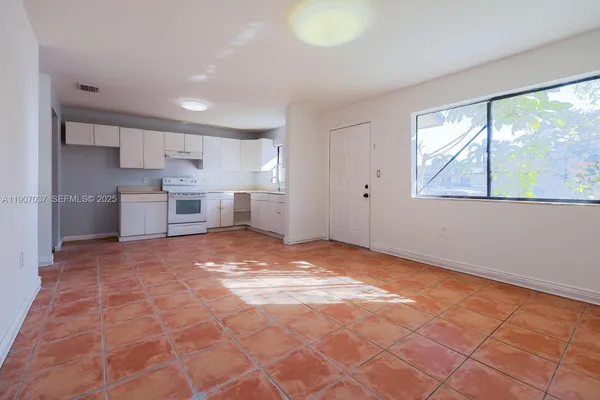 a view of a kitchen with a sink and a window