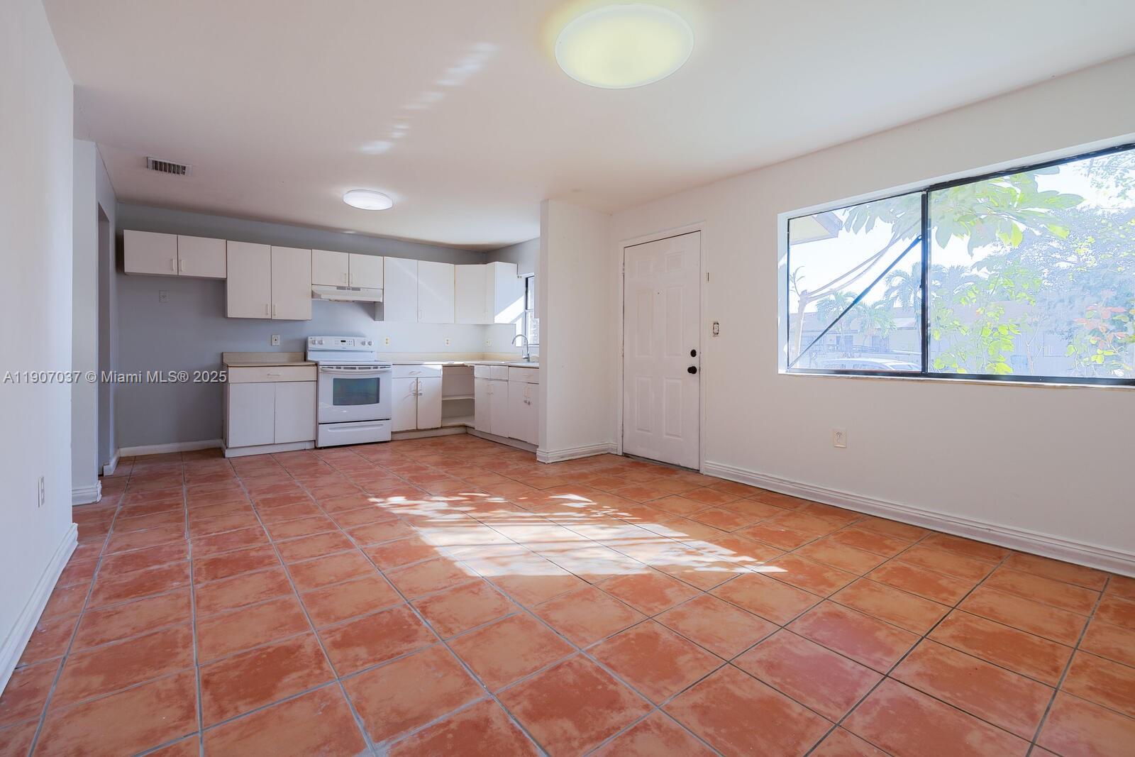 28147 Southwest 142nd Court Homestead, FL 33033 - Photo 3 of 16 a view of a kitchen with a sink and a window