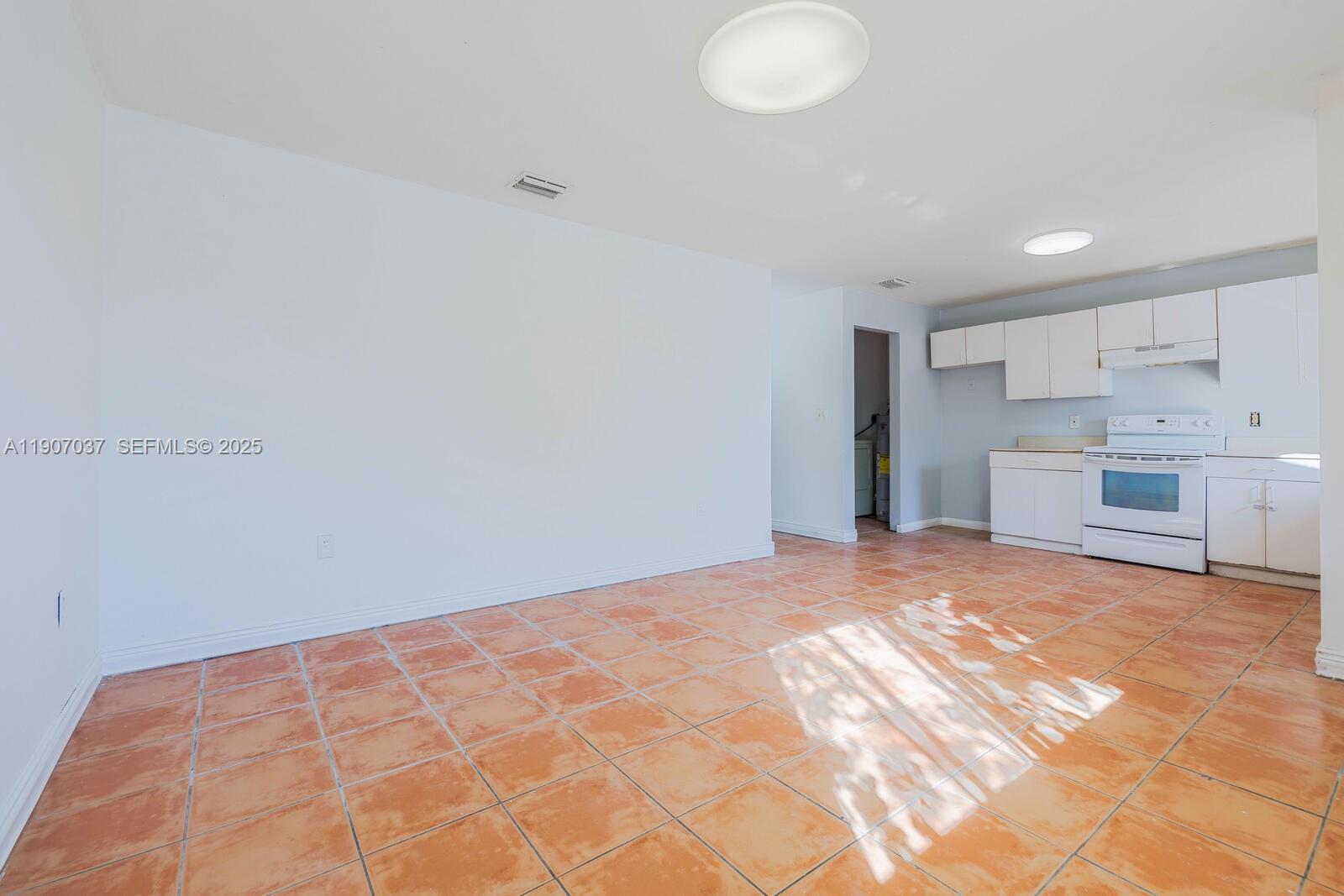 28147 Southwest 142nd Court Homestead, FL 33033 - Photo 4 of 16 a view of an empty room with kitchen and a window