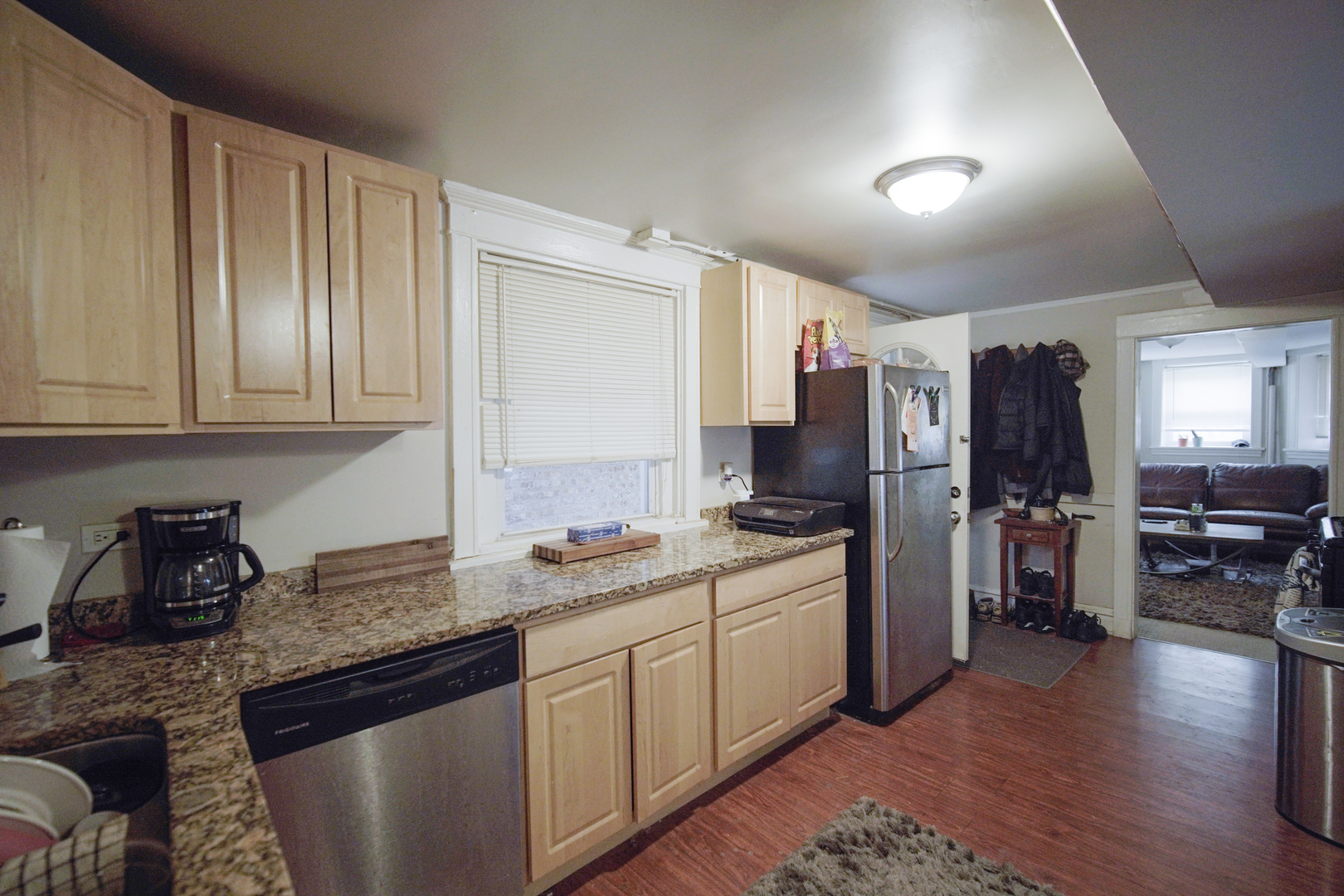 1077 North Paulina Street, Unit G Chicago, IL 60622 - Photo 5 of 6 a kitchen with a sink stove and refrigerator
