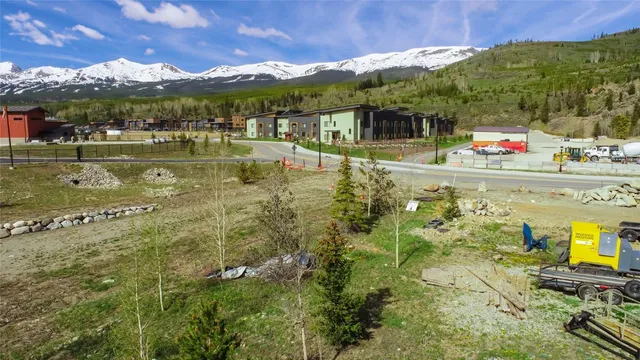a backyard of a house with fire pit and outdoor seating