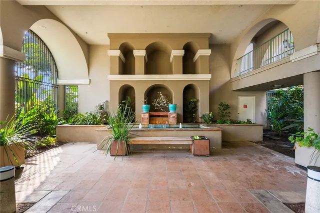 a lobby with furniture and flowers