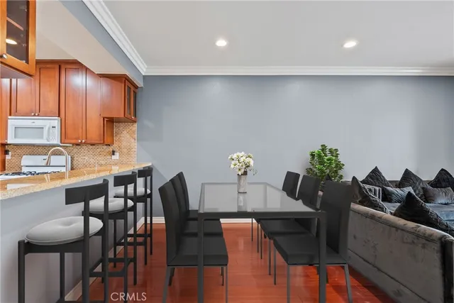 a view of a dining room with furniture and wooden floor