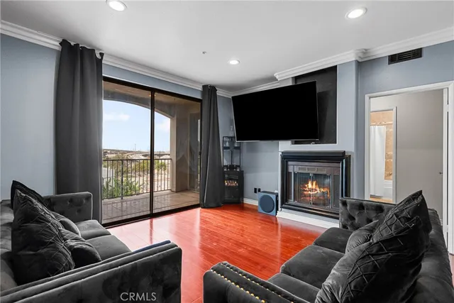a living room with furniture a flat screen tv and a fireplace