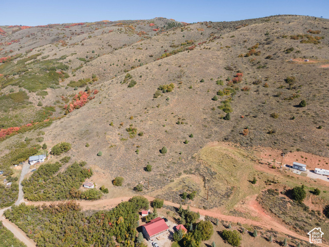 3378 Spring Way, Unit 410 Huntsville, UT 84317 - Photo 23 of 24 Expansive hillside property featuring diverse natural terrain, scattered mature trees, and a distant mountain range