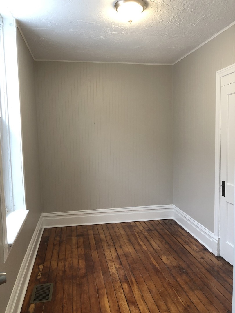 827 West 33rd Place, Unit 2F Chicago, IL 60608 - Photo 13 of 23 a view of wooden floor in an empty room