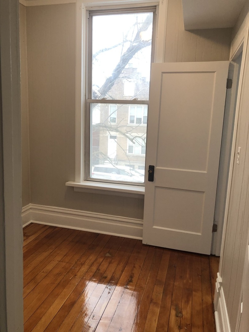 827 West 33rd Place, Unit 2F Chicago, IL 60608 - Photo 17 of 23 a view of a small space with wooden floor and a window