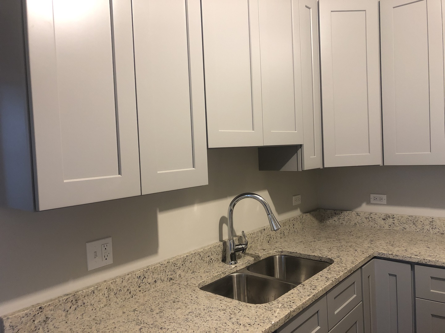 827 West 33rd Place, Unit 2F Chicago, IL 60608 - Photo 4 of 23 a kitchen with granite countertop white cabinets and sink
