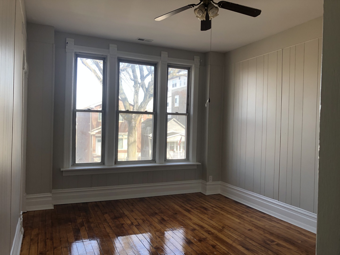 827 West 33rd Place, Unit 2F Chicago, IL 60608 - Photo 5 of 23 an empty room with wooden floor and windows