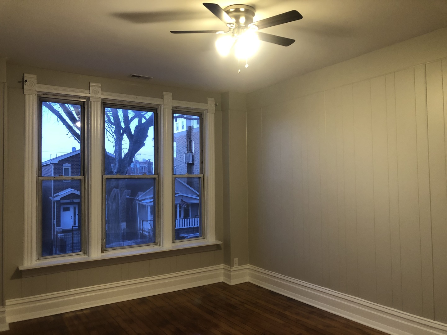 827 West 33rd Place, Unit 2F Chicago, IL 60608 - Photo 6 of 23 a view of empty room with wooden floor and fan