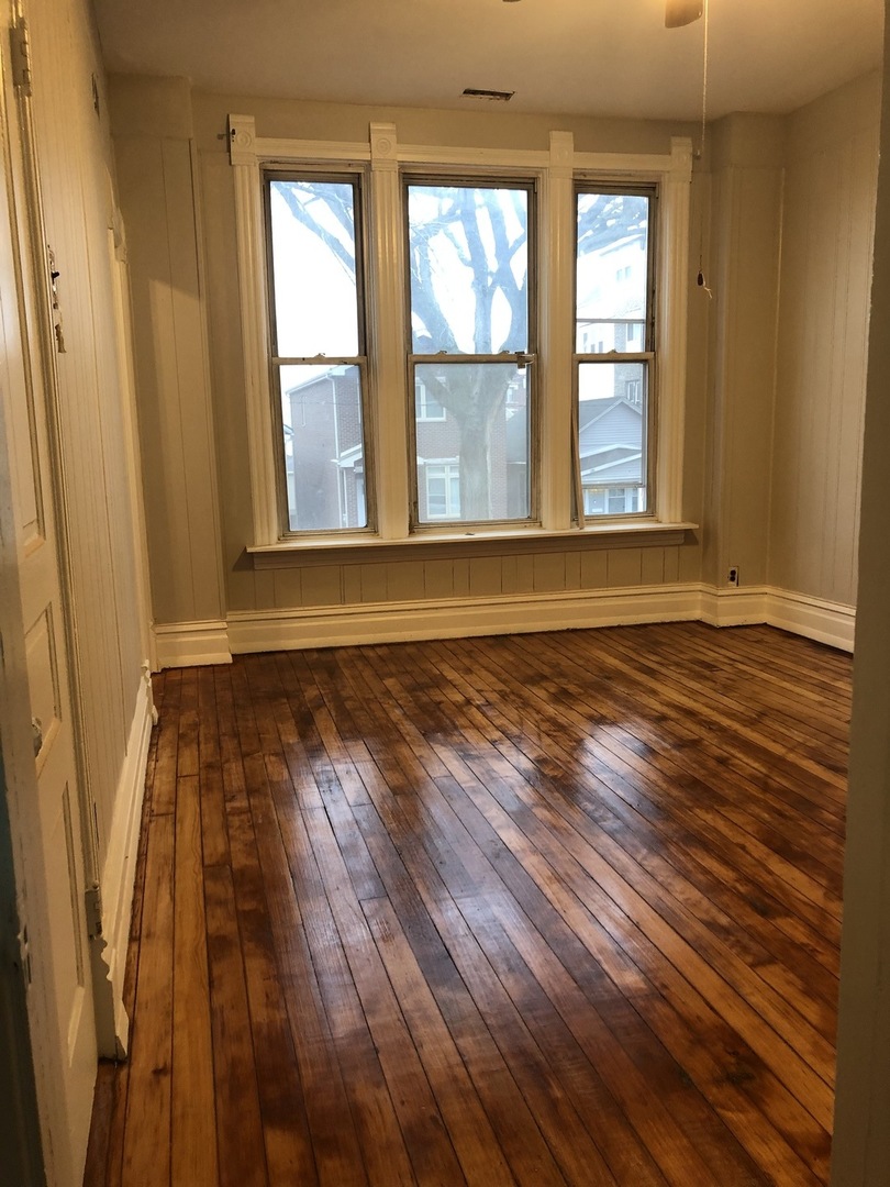 827 West 33rd Place, Unit 2F Chicago, IL 60608 - Photo 8 of 23 a view of a room with wooden floor and window