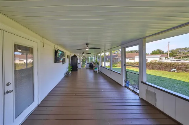 a view of a patio with table and chairs potted plants and palm tree
