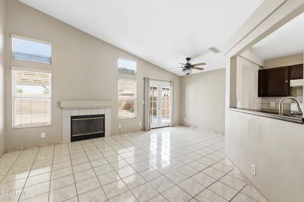 a view of an empty room with a fireplace and a window