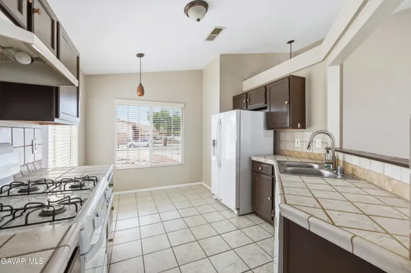 a kitchen with a sink appliances and cabinets