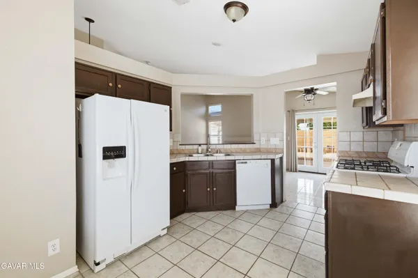 a kitchen with a refrigerator and a stove