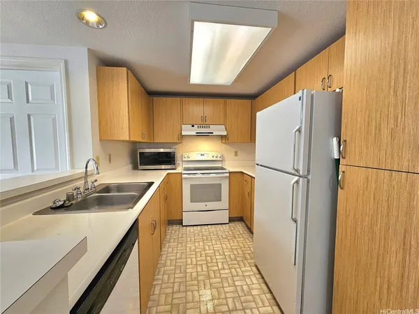 a view of a kitchen with a sink and a ceiling fan