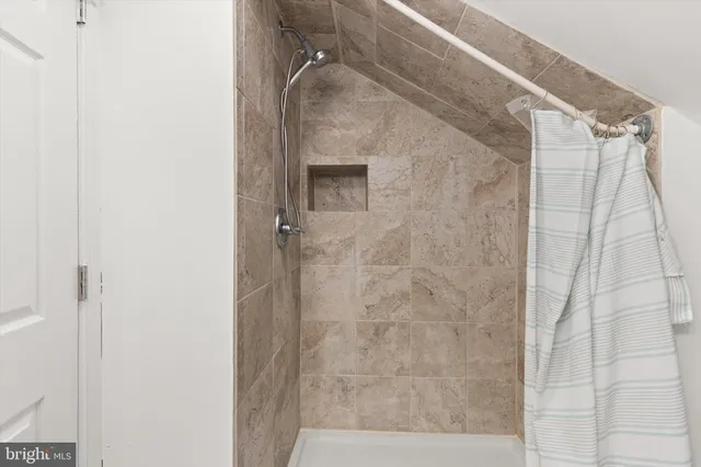 a view of walk in closet with clothes