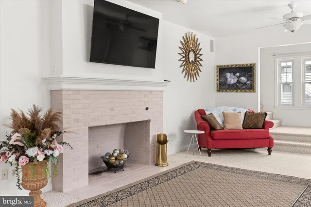 a living room with furniture fireplace and a flat screen tv