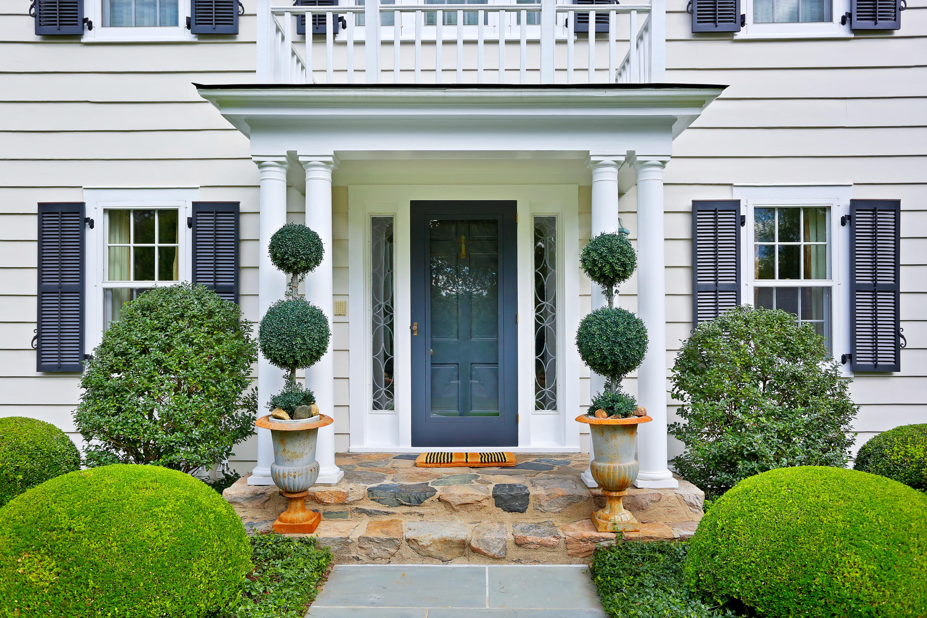913 Ponus Ridge Road New Canaan, CT 06840 - Photo 2 of 32 a front view of a house with plants and entryway