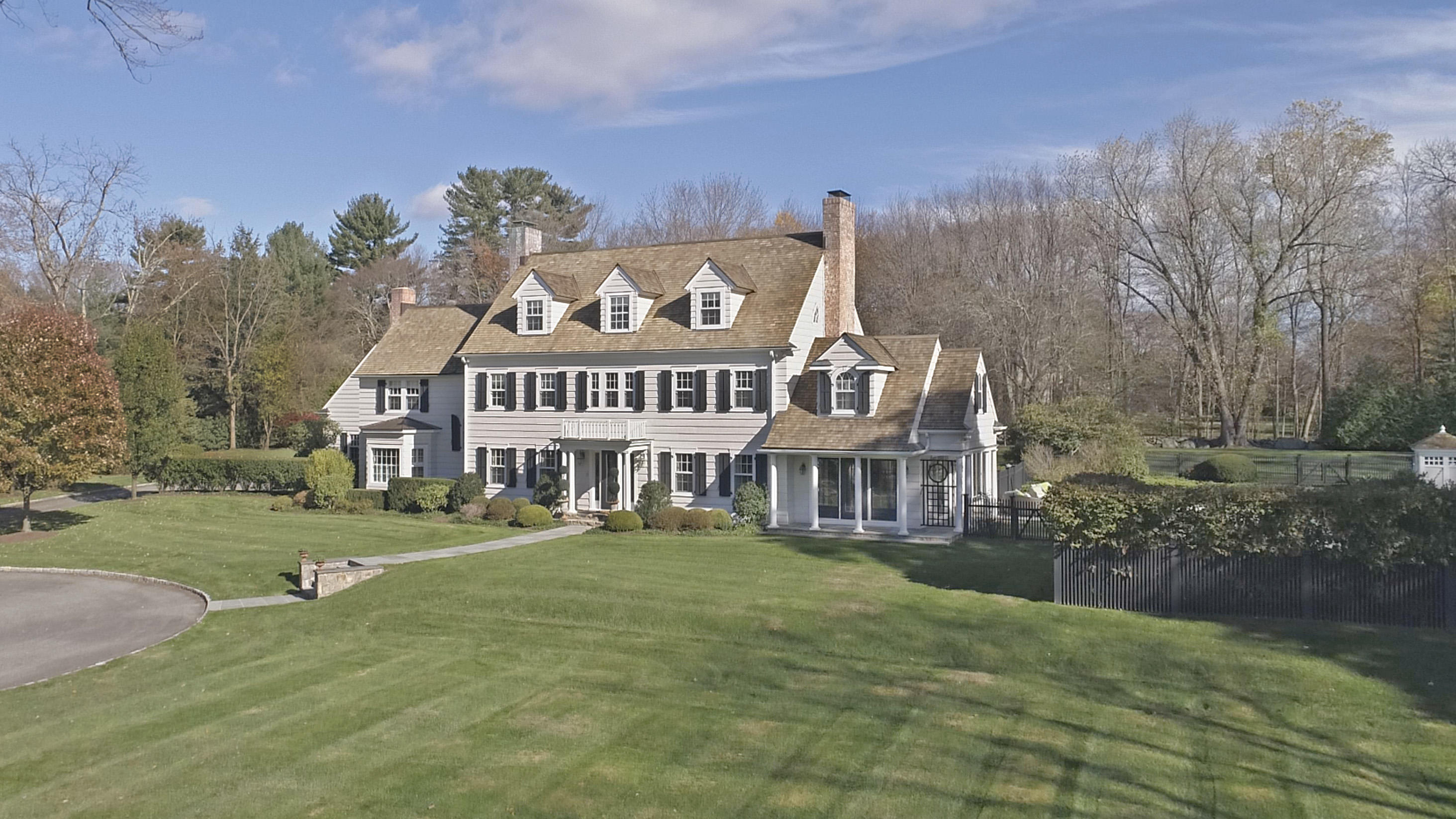 913 Ponus Ridge Road New Canaan, CT 06840 - Photo 3 of 32 a view of a big building with a big yard and large trees