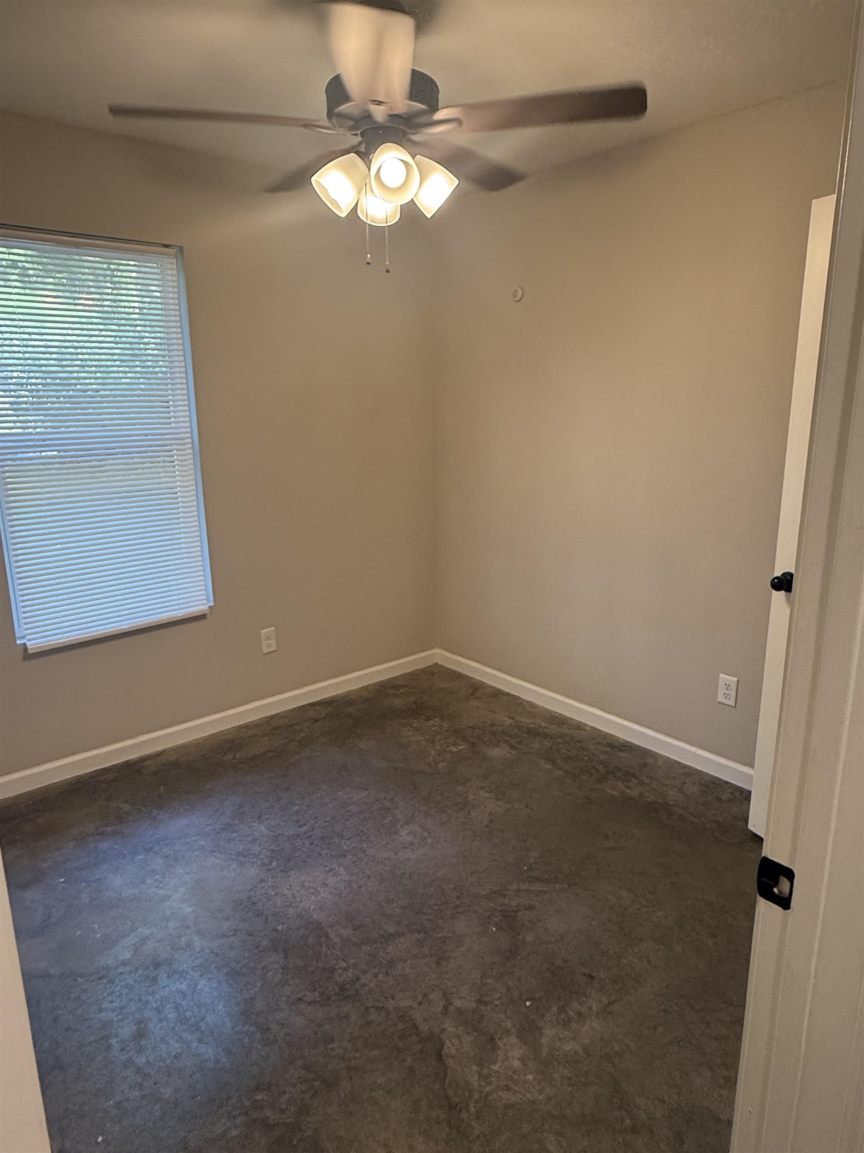 4589 Range Line Road Memphis, TN 38127 - Photo 13 of 25 an empty room with a chandelier fan and windows