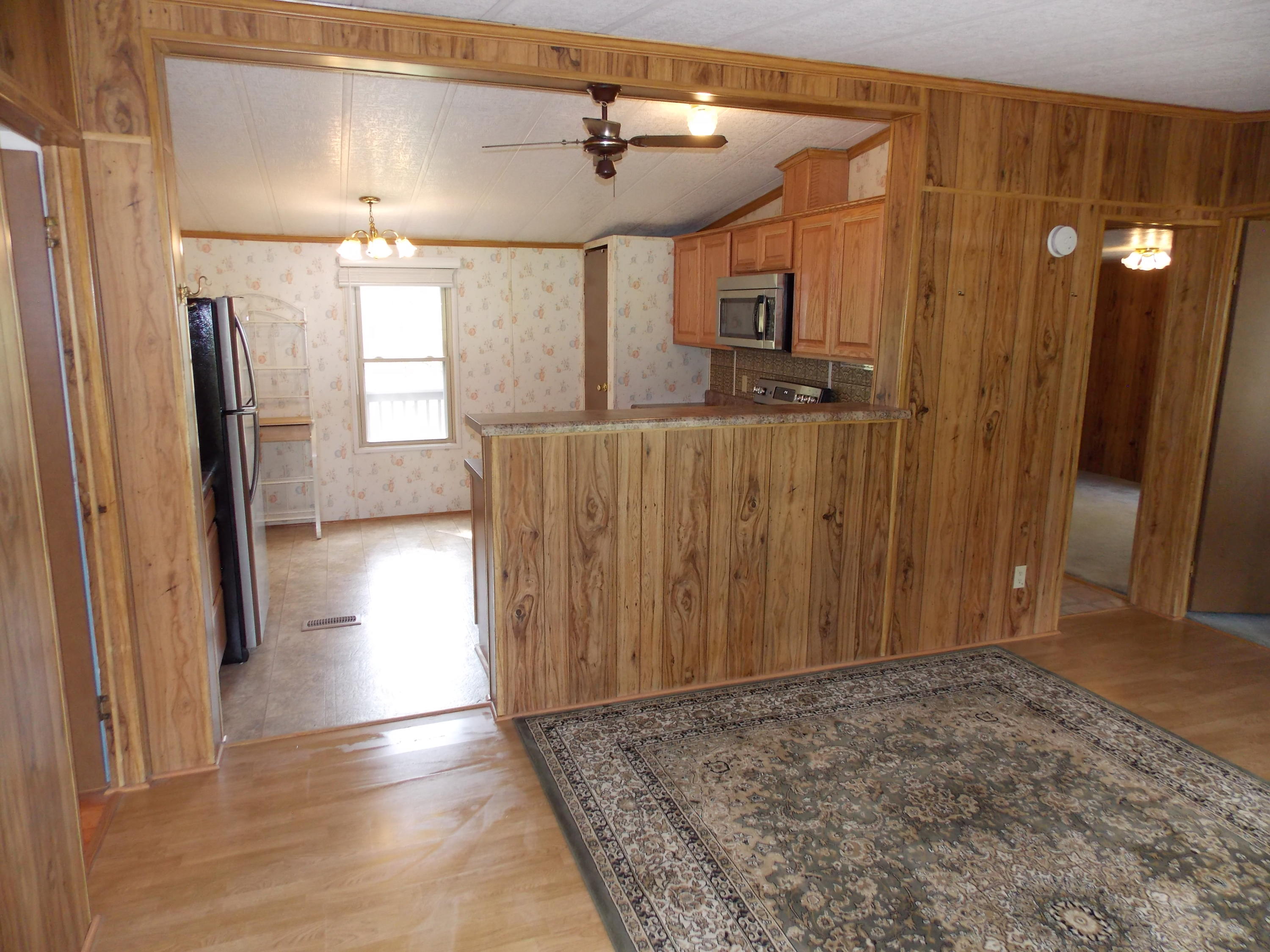 1286 Lester Road Northwest Riner, VA 24149 - Photo 12 of 25 a view of a hallway to a bedroom with wooden floor and windows