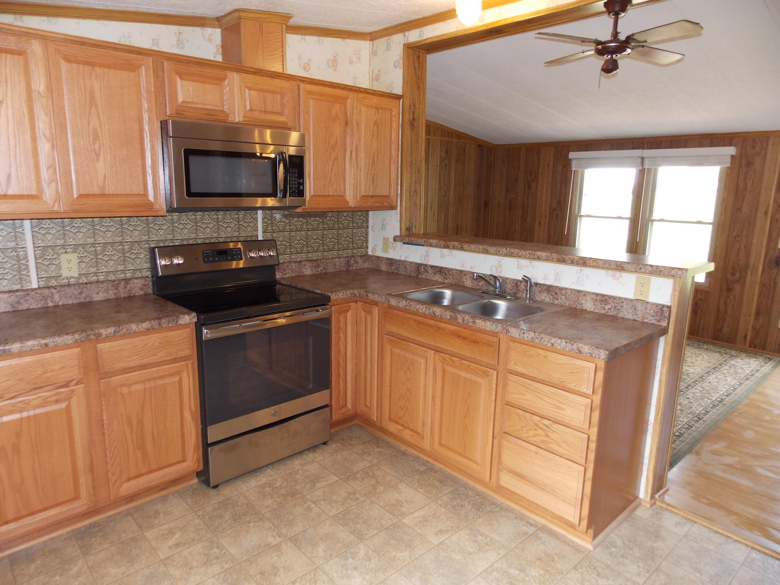 1286 Lester Road Northwest Riner, VA 24149 - Photo 15 of 25 a kitchen with stainless steel appliances granite countertop a stove a sink and a microwave