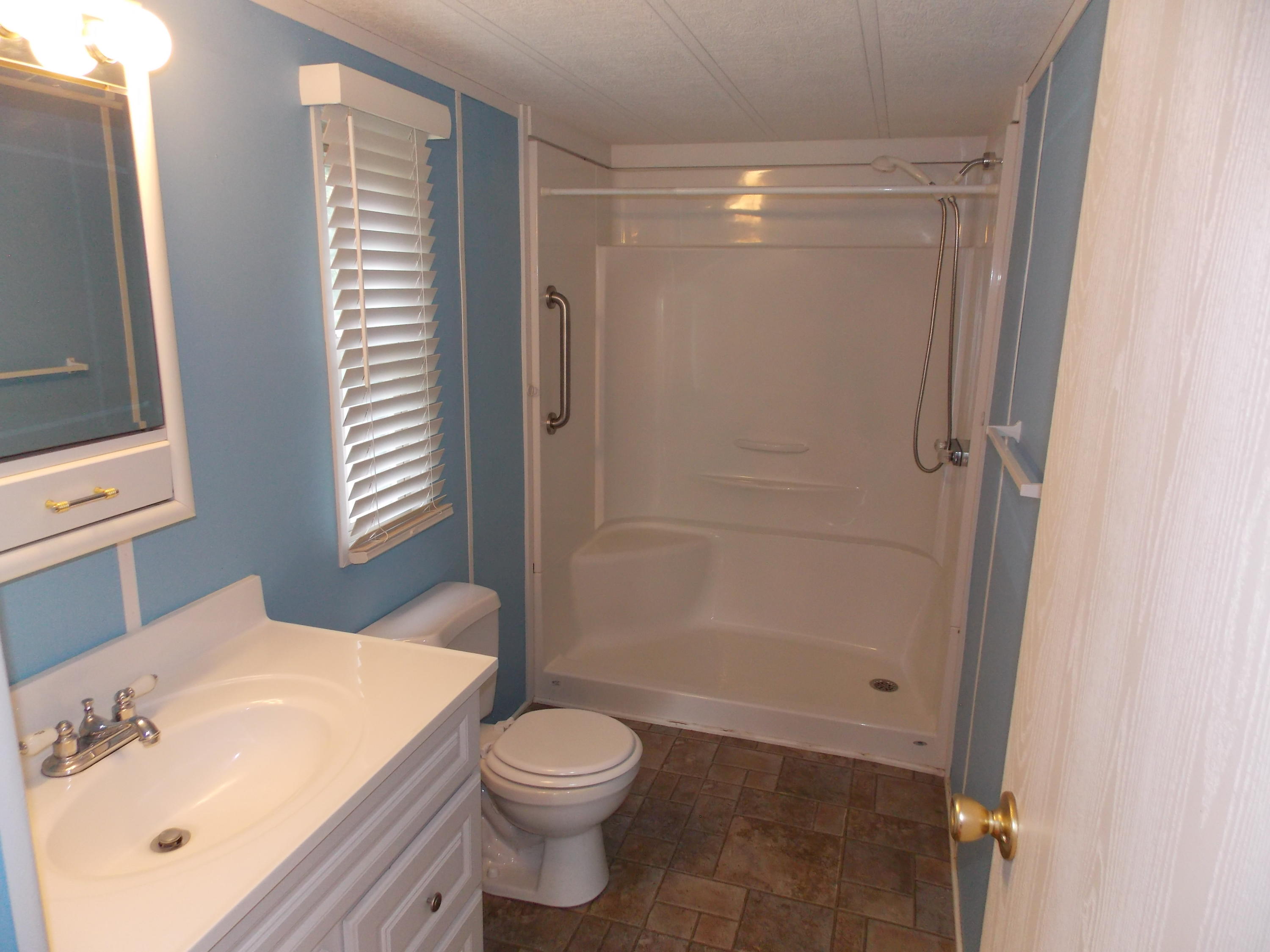 1286 Lester Road Northwest Riner, VA 24149 - Photo 18 of 25 a bathroom with a sink mirror vanity and toilet