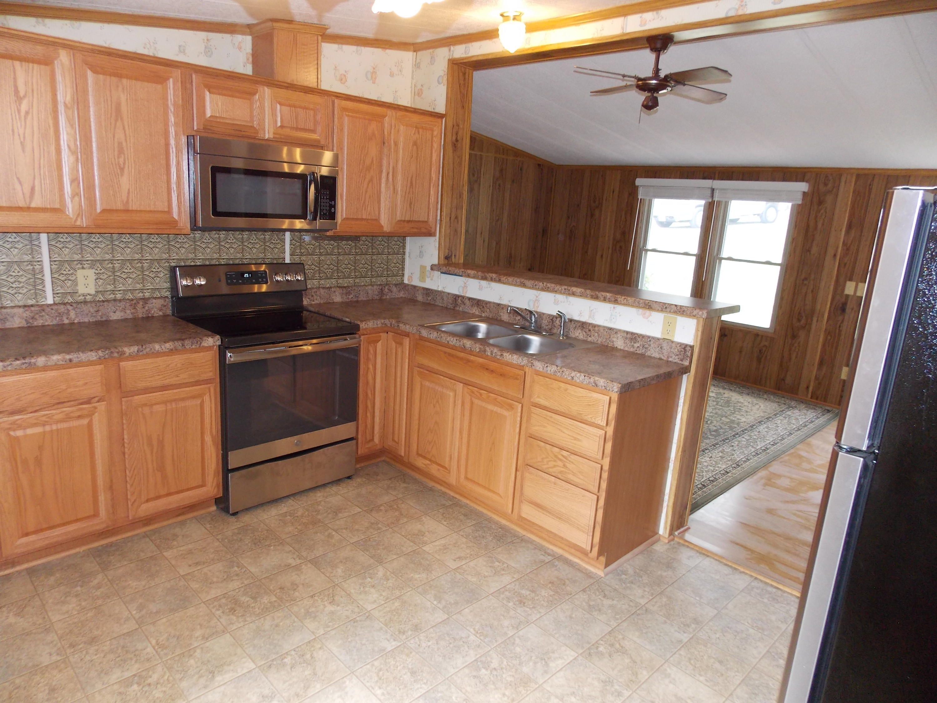 1286 Lester Road Northwest Riner, VA 24149 - Photo 24 of 25 a kitchen with stainless steel appliances granite countertop a stove a sink and a microwave