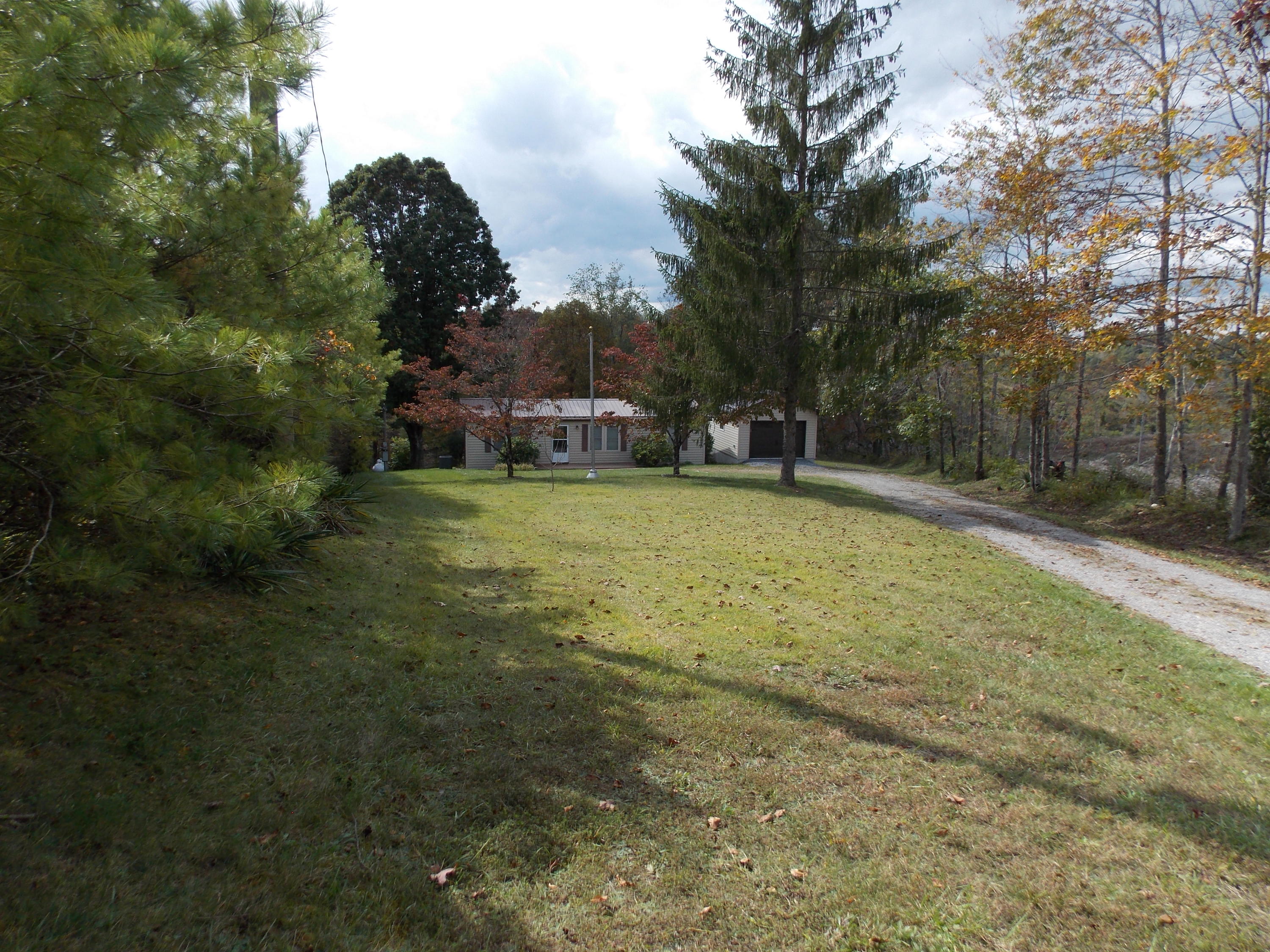 1286 Lester Road Northwest Riner, VA 24149 - Photo 4 of 25 a view of a swimming pool with a yard and large trees