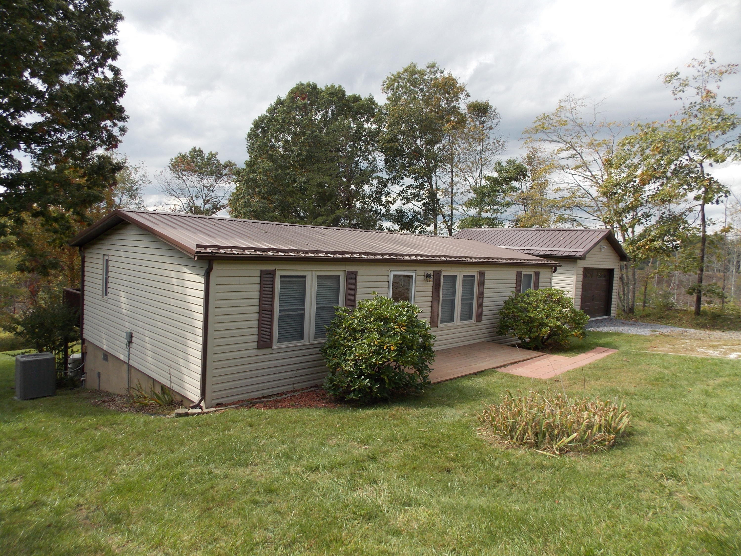 1286 Lester Road Northwest Riner, VA 24149 - Photo 9 of 25 a view of a house with a yard and potted plants