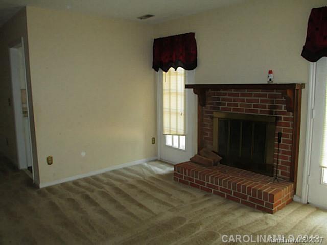 8611 Waterrock Road Charlotte, NC 28214 - Photo 2 of 8 a living room with furniture and a fireplace