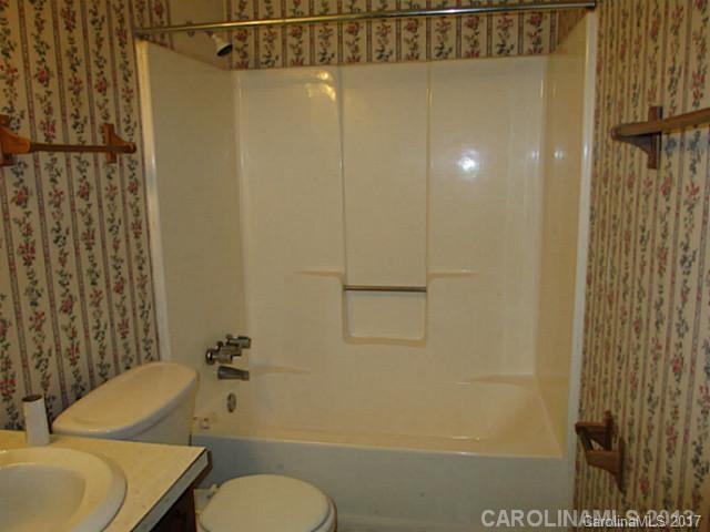8611 Waterrock Road Charlotte, NC 28214 - Photo 6 of 8 a bathroom with a sink a toilet and shower