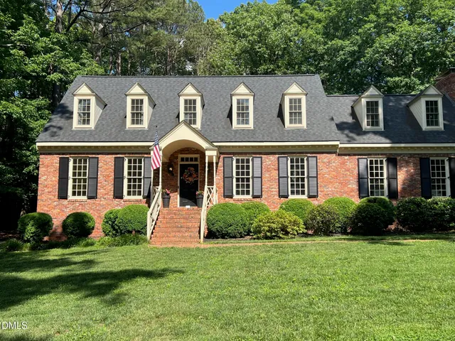 a front view of a house with garden and porch