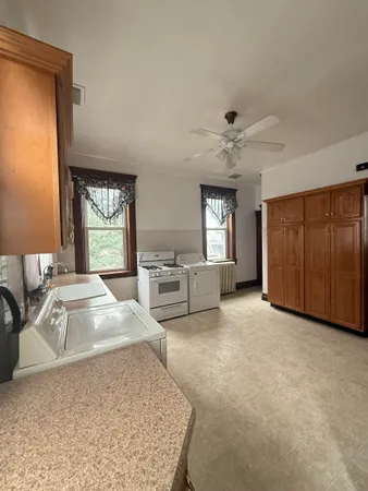 a view of a livingroom with a couch and large window
