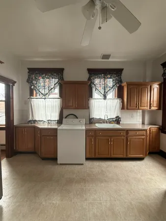 a large kitchen with a window and stainless steel appliances