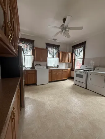 a kitchen with refrigerator and window