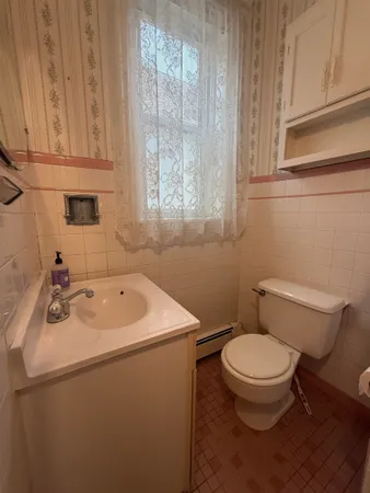 a bathroom with a sink a toilet and a mirror