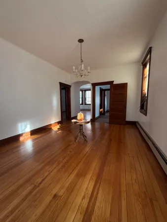wooden floor in an empty room with a window