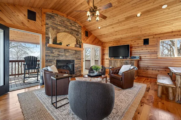 a living room with furniture a fireplace and a flat screen tv