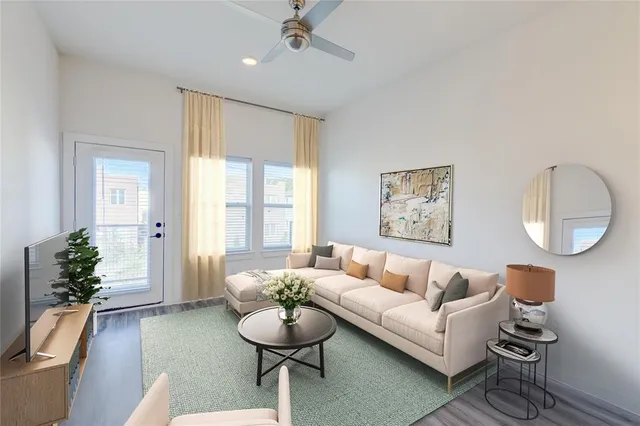 a living room with furniture potted plant and a chandelier