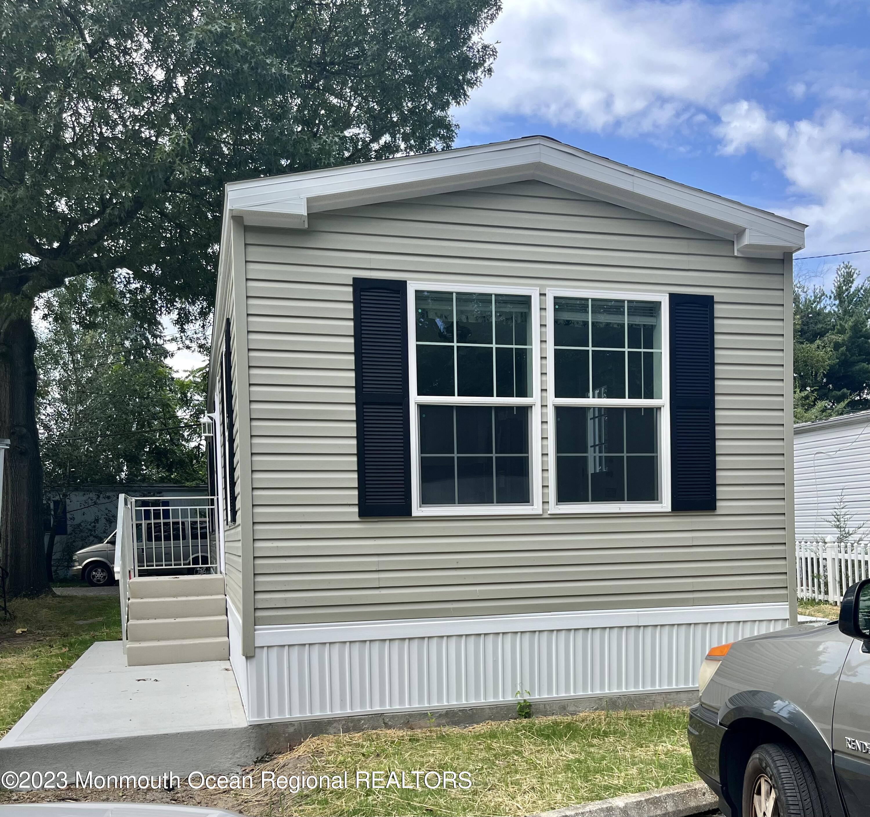 a front view of a house with a garden