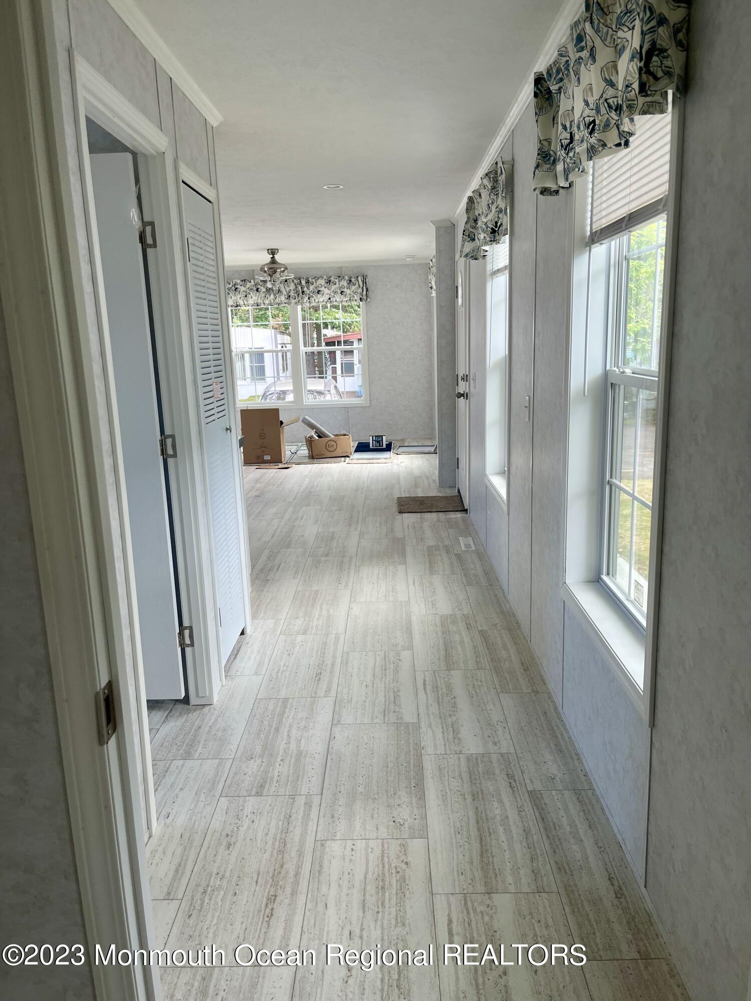 6 C Trail Brick, NJ 08724 - Photo 11 of 17 a view of hallway with wooden floor and windows
