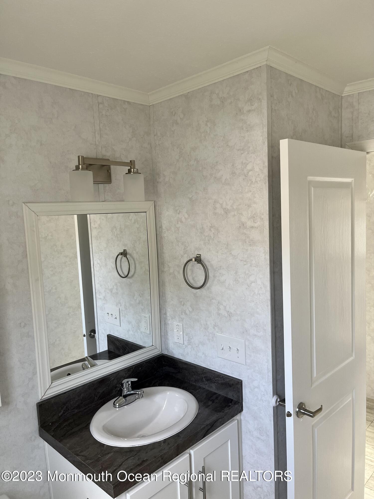 6 C Trail Brick, NJ 08724 - Photo 13 of 17 a bathroom with a sink and a mirror