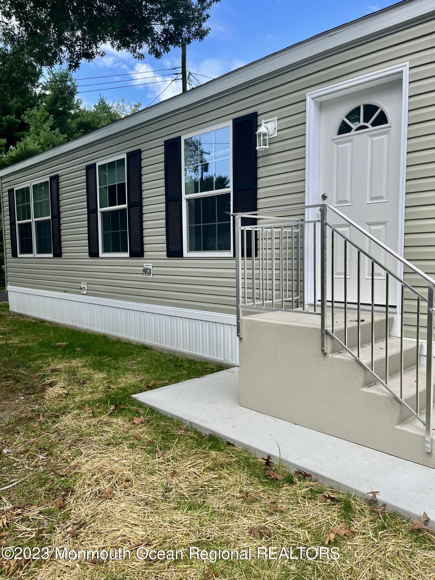 6 C Trail Brick, NJ 08724 - Photo 2 of 17 a view of house with backyard porch and furniture