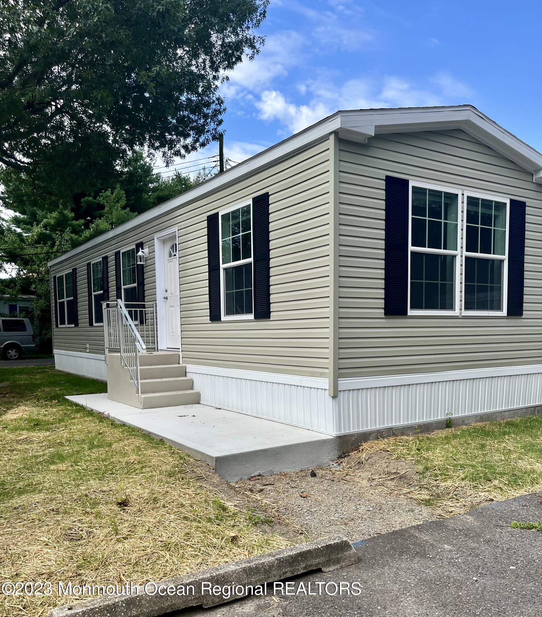 6 C Trail Brick, NJ 08724 - Photo 4 of 17 a view of a house with a wooden deck and a yard