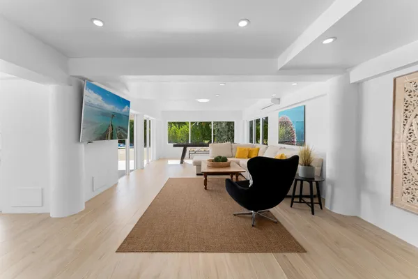 a view of a dining room with furniture and wooden floor