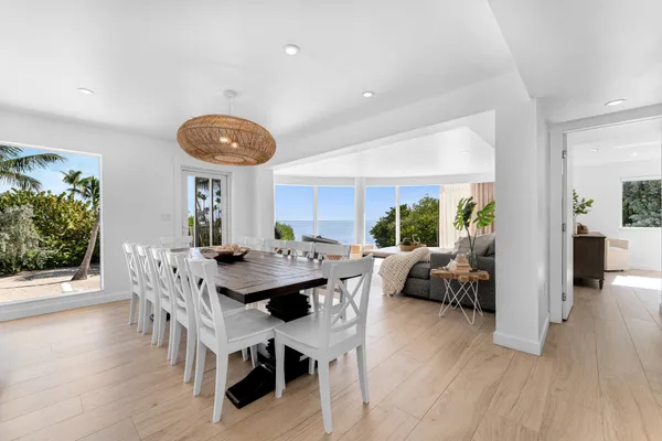 a living room with furniture a wooden floor and a large window