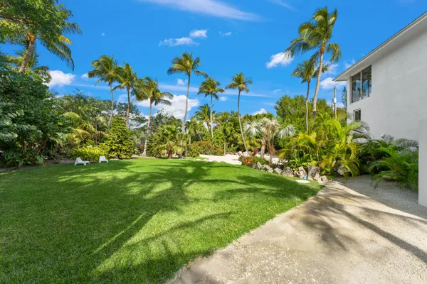 a view of a livingroom with furniture and floor to ceiling window