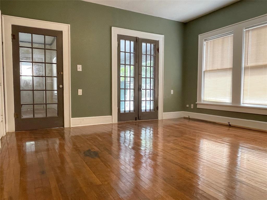 613 Northwest 5th Street Mineral Wells, TX 76067 - Photo 16 of 34 wooden floor in an empty room with a window